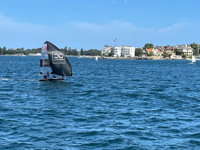 Manly 13ft skiff sponsored by Cadence & Co competing on Sydney Harbour